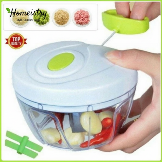 Handheld food chopper with green accents being used to chop vegetables, branded 'Homeistry'.