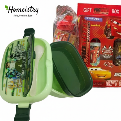 Green children's lunchbox with cartoon design, red gift box with toys in the background, Homeistry brand visible.