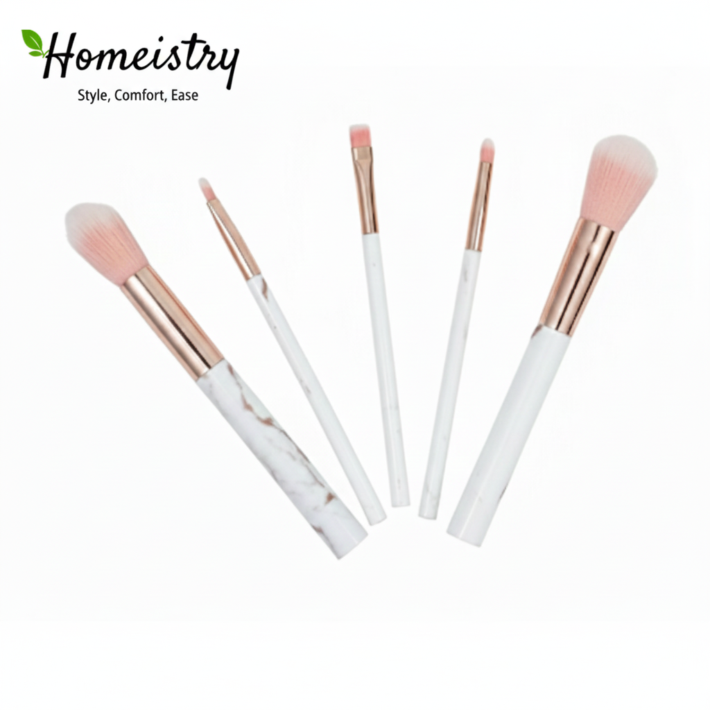 Set of makeup brushes with rose gold and white handles on a white background, branded with Homeistry.