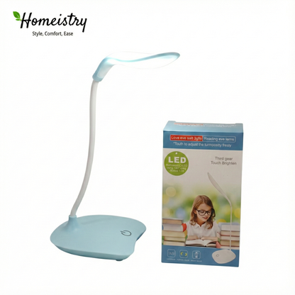 Light blue LED desk lamp with packaging featuring a child reading on a white background, branded 'Homeistry'.