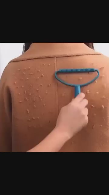 Demonstration of blue manual lint remover scraping fuzz off a beige wool coat.